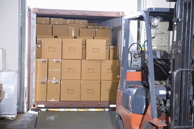 Loading boxes into a trailer in a distribution warehouse