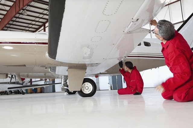 Aerospace manufacturing workers inspecting an aircraft