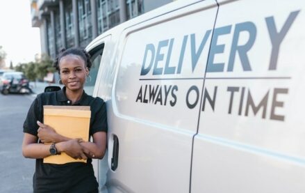 Outsourced third-party delivery provider standing outside delivery vehicle