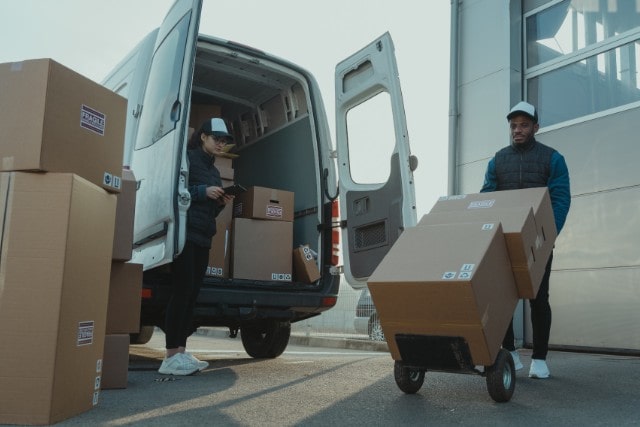 Warehouse workers loading a delivery truck