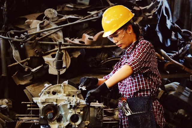 Woman Working on Vehicle Part