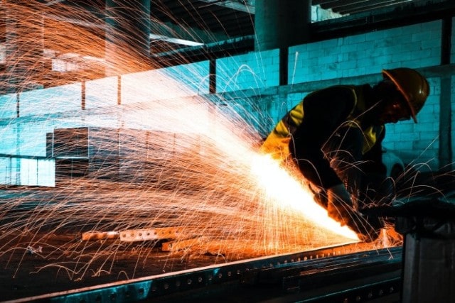 Worker Cutting into Metal