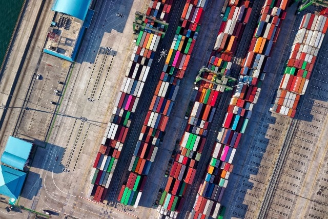 Supply chain port with freight cargo and shipping containers
