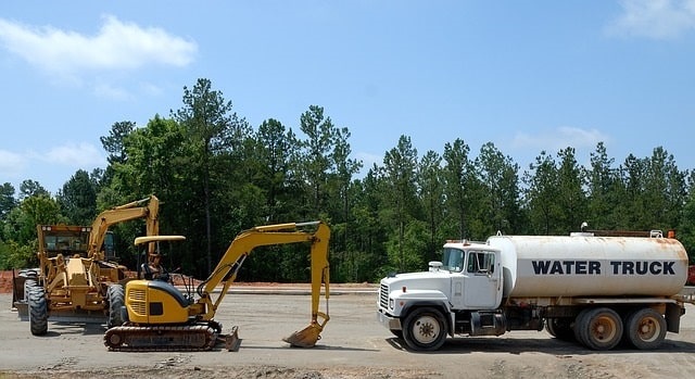 Construction site with a water truck and heavy equipment 