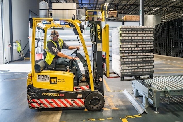 Equipment operator using a forklift