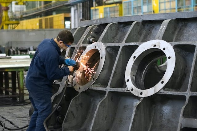 Worker working with equipment at a manufacturing plant 
