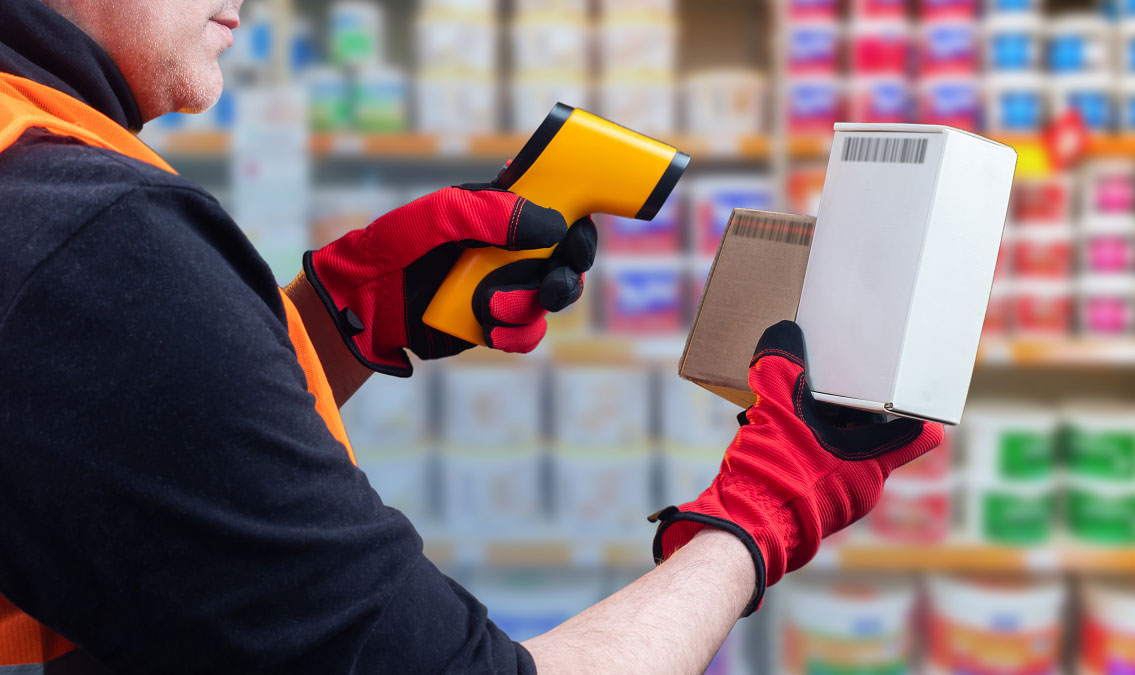 Worker scanning barcode labels with a handheld barcode scanner for product identification