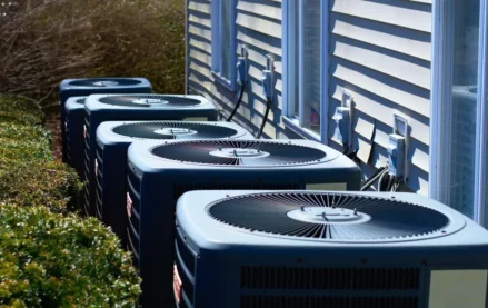 HVAC units in a row outside of an apartment building