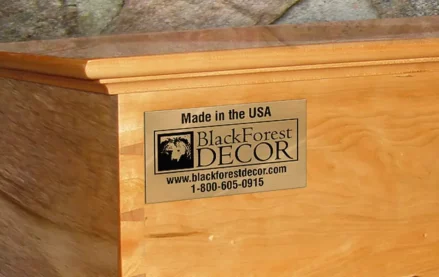 A brass nameplate with a company name & logo