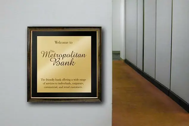 Brass sign welcoming customers to a bank