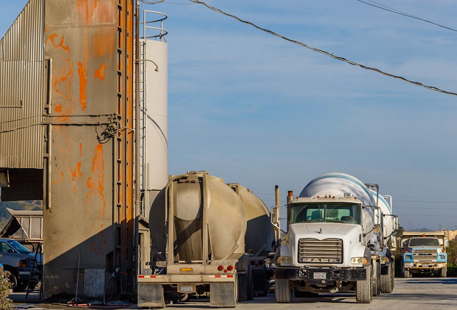 Fuel tankers refilling at a fuel tank